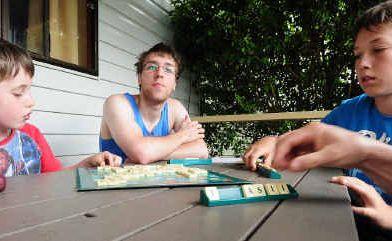 Patrick Leary, Michael Nowara and Clancy Leary play scrabble during the rain. Patrick Leary, Michael Nowara and Clancy Leary play scrabble during the rain.
